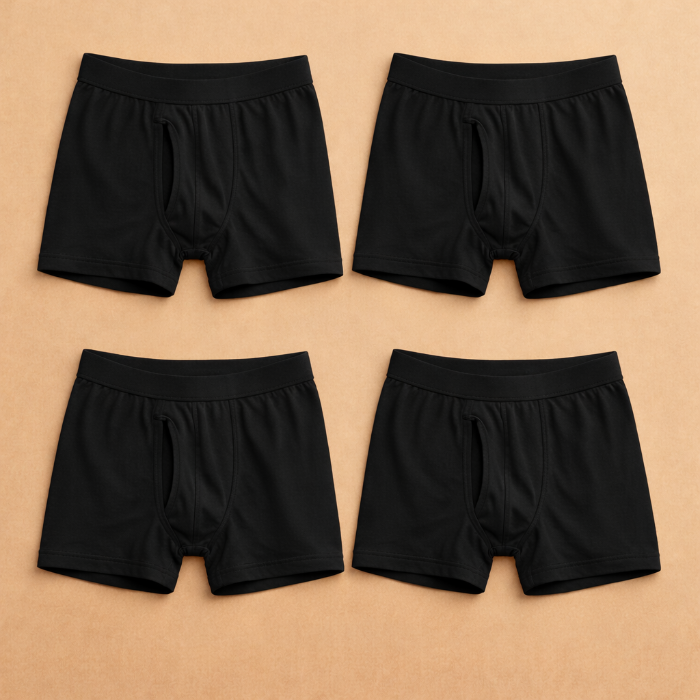 Four pairs of black boxer briefs arranged in a grid on a beige background